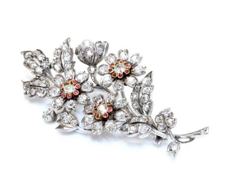 A Victorian diamond, ruby and pearl spray brooch, c.1880,with three flower head clusters. Each one set with a central old Eur