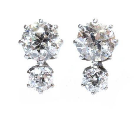 A pair of two stone diamond stud earrings,with an old European cut diamond, estimated as approximately 0.70ct each, claw set 