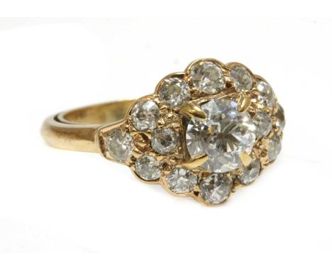 A lozenge shaped diamond cluster ring,with an old European cut diamond, estimated as approximately 0.75ct, four claw set to t