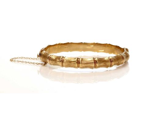 A 9ct gold hollow hinged bangle, by Henry Griffith and Sons,of bamboo form, with a Venetian textured finish, concealed box cl