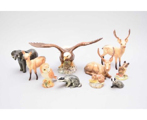 An assorted collection of Beswick wild animals and birdsincluding a standing stag, lying stand, doe and dawn, a Bald Eagle, t