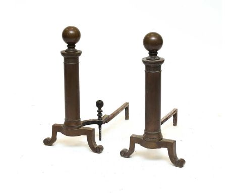 A pair of large 18th century style brass andirons, of gun barrel form with spherical finials, 62cm high, with a cast iron gra