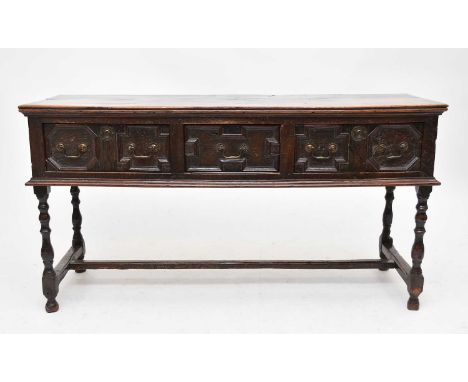 A 17th century oak geometric dresser base, the moulded top above three frieze drawers having geometric moulded fronts and bra