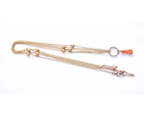 A yellow metal guard chain with chased bead spacers, the yellow metal bolt ring clasp with '9ct' plaque, suspending carved co
