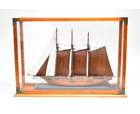 A reproduction folk art cased model ship, late 20th century, the unnamed three-masted merchant type vessel modelled in full s
