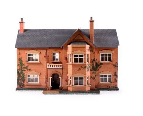 An early-mid 20th century dolls house, of 'T' form and Victorian in style, printed and painted with ivy-clad brickwork, with 