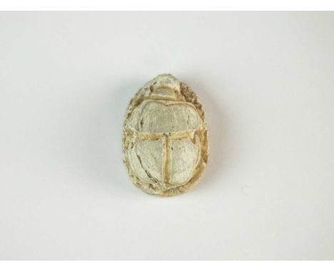 Faience scarab, with well modelled body displaying the carapace, and legs folded along the side of the body; pierced for susp