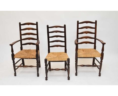 A set of 8, 20th century stained ash ladder back chairs, with rush seats, some seats damaged (8)Minor chips, dents and scratc