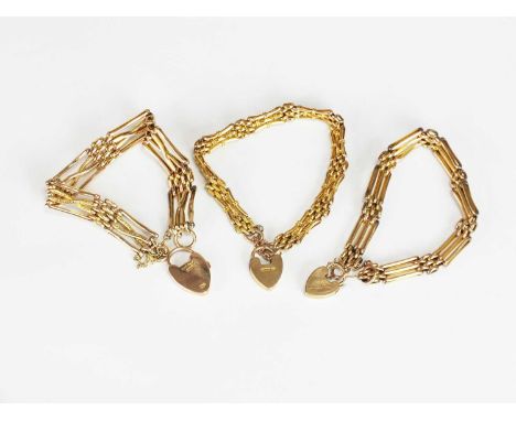 Three yellow metal gate link bracelets, each with padlock clasps, two stamped ‘9ct’ and one stamped ‘9c’, total weight approx