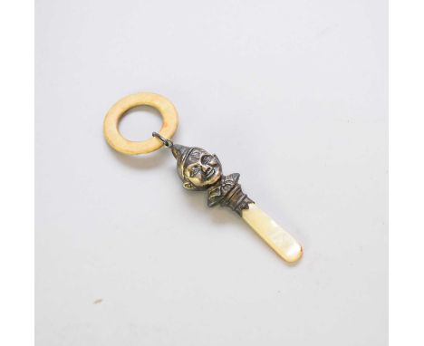 A silver mounted rattle, W.H.C., Birmingham 1939, the silver 'Peter Pan' mount with mother of pearl handle bone teether ring 