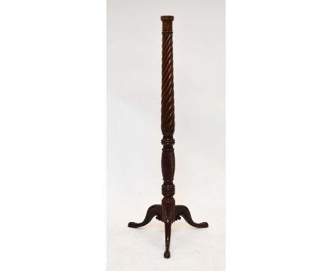 A Victorian mahogany torchere stand, with laurel capital on a spiral-reeded and knopped stem, raised on four carved scroll fe