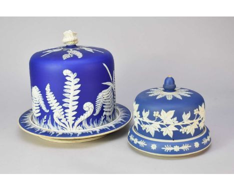 Two Staffordshire blue and white jasperware cheese domes with stands, 19th century, unmarked, 16cm and 27cm highFern cheese d