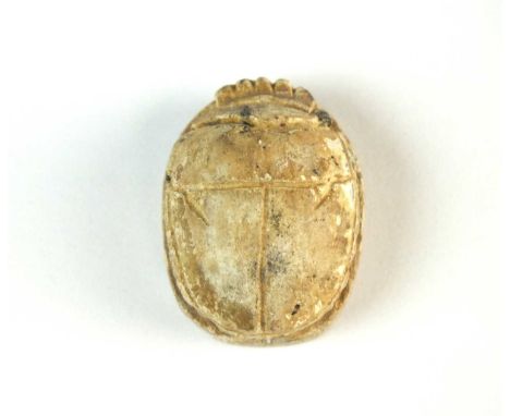 Faience scarab with modelled carapace and legs folded to the side of the body; pierced for suspension. To the underside is th