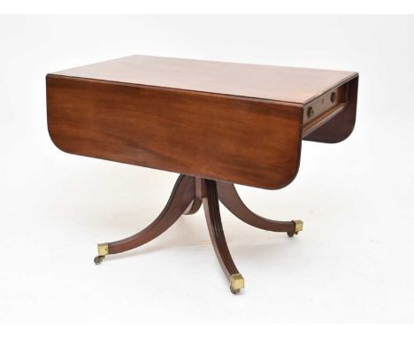 A late Regency, mahogany pedestal, breakfast table, the drop-flap reeded rectangular top, above an end frieze drawer, opposed