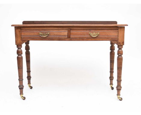 An Edwardian mahogany dressing table, the moulded top with plain gallery back above two frieze drawers, raised on ring-turned