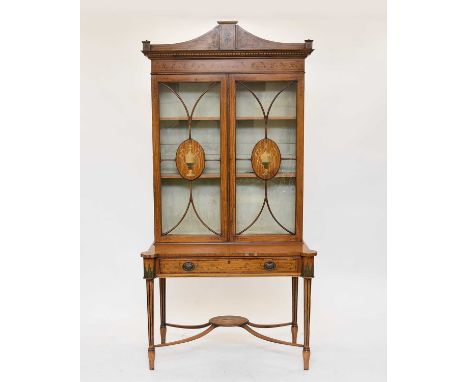 A late Victorian/Edwardian painted satinwood cabinet on stand, painted with scrolling foliage, paterae and twin handled urns,