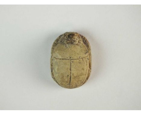 Faience scarab with modelled carapace and legs folded to the side of the body; pierced for suspension. To the underside is a 