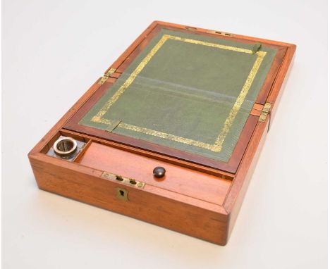 An Edwardian walnut writing slope, of plain rectangular outline, opening to a fitted interior with green tooled leather skive