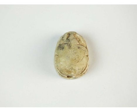 Faience scarab with plain body, and just the head area defined, the legs folded to the side of the body; pierced for suspensi