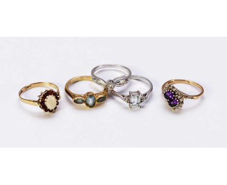 A 9ct gold opal and garnet oval cluster ring, size P, together with a 9ct gold amethyst and diamond crossover ring, size P, a