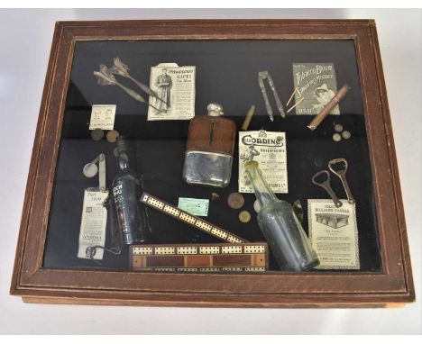 A cased collection of bar memorabilia, including vintage bottles, darts, a hip flask, cigar, cribbage board and appropriate a