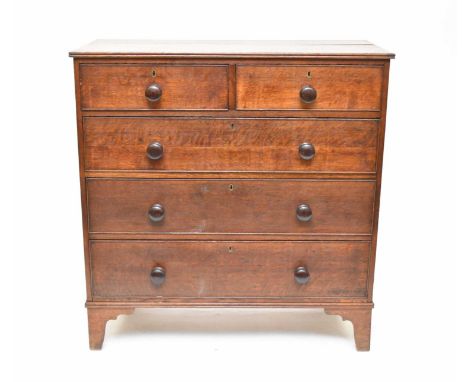 An early 19th century oak chest of two short and three long graduated, cockbeaded drawers, with a reeded rectangular top and 