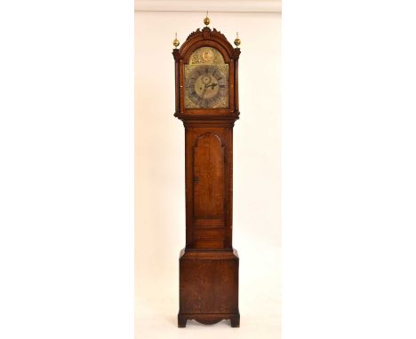 A George III inlaid oak brass dial longcase clock, the arched hood with three brass finials, the door with chequer stringing 