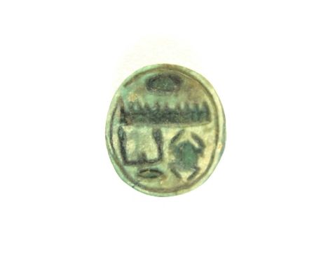 Faience button seal, pierced for suspension. To the underside are hieroglyphs spelling out “Menkheperre, the throne name of T
