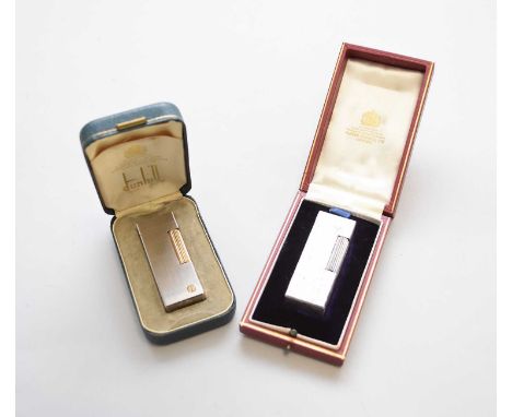 Two cased Dunhill lighters, the first brushed stainless steel with yellow metal strike wheel and Dunhill 'd' logo, the second