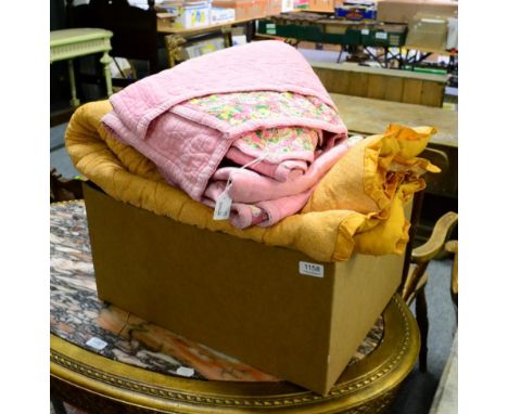 Circa 1930s quilts and eiderdown including a pink cotton and floral printed quilt, 170cm by 215cm, another similar in mustard