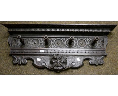A carved wooden coat rack 