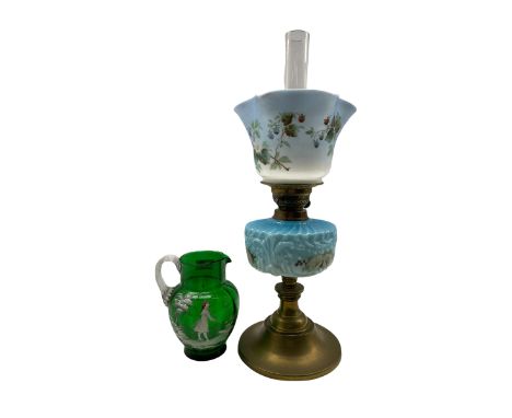 Table oil lamp with glass reservoir and shade and a Mary Gregory style green glass jug