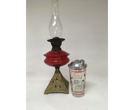 An oil lamp with ruby red glass reservoir and a mid 20th century glass cocktail shaker (2)