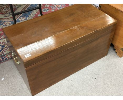 A Mahogany Trunk of rectangular shape with applied bras handles. 91x46cm