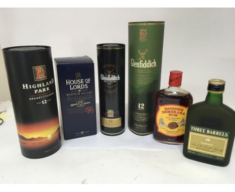 A collection of 12 year Highland Scotch Whisky 700cl bottles a bottle of rum and Three Barrels Brandy. (6)