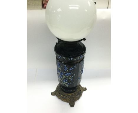 A Victorian oil lamp and shade, the font and base decorated with raised floral decoration. Shipping category D.