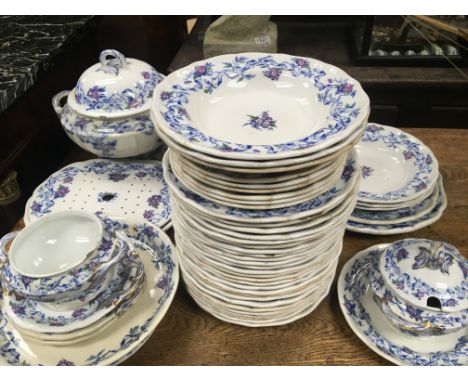 A large Victorian ceramic dinner set decorated with a pattern of flowers (a lot)