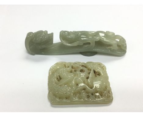 A carved jade belt hook and a buckle (2). Shipping category A.