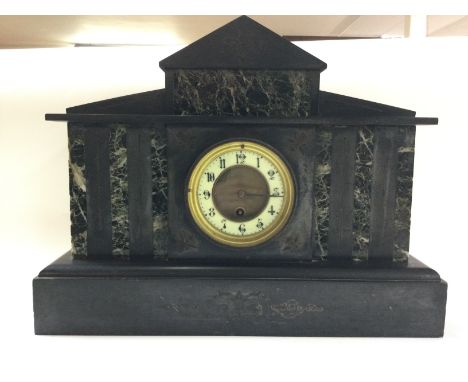 A Slate mantle clock, with pendulum. Dimensions 14x44x34cm