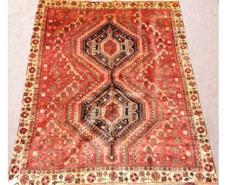 Shiraz carpet with double hexagon over red ground floral border 282cm x 150cm Condition Report Click here for further images,
