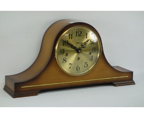 Mahogany finished mantel clock, of arched form Brush metal dial, Arabic numeral, raised on bracket feet, German movement stri