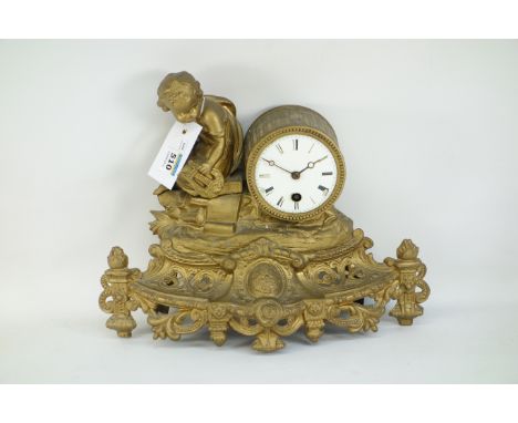 A late 19th century gilt spelter mantle clock, with enameled face, Roman numerals, mounted by putti with harp, over pierced e