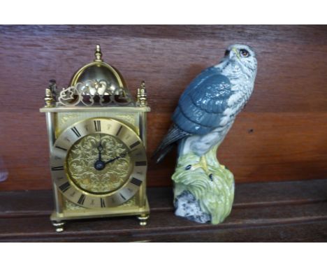 A brass lantern clock with battery movement and a Beswick Merlin Beneagles decanter, (lacking contents) 