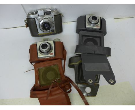 Three cameras in cases, Balda and two Kodak 