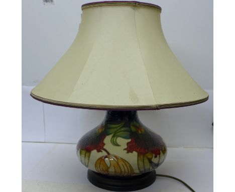 A large Moorcroft tube line squat shaped lamp base in the Anna Lily design, designer Nicola Stanley, with shade, height with 