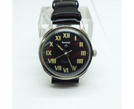 An HMT military wristwatch, with broad arrow on the dial and case back 