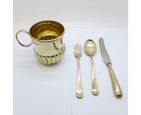 A Scottish silver Christening mug and a silver fork, spoon and knife set, 204g 