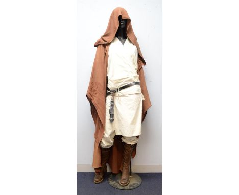 Star Wars - Jedi Costume. Replica Jedi outfit from Star Wars (1977-1983) with prop lightsabre hilt (resin) on female display 