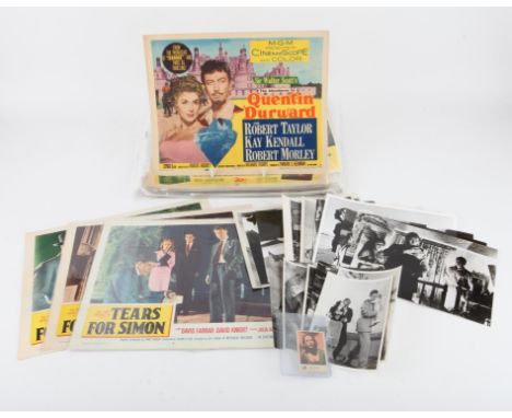Large collection of lobby cards including Fury at Furnace Creek, The Comedians, The Charge of the Light Brigade, S.O.S. Titan