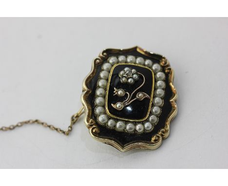 A 19th century gold, black enamel and split pearl mourning brooch with glazed hair compartment